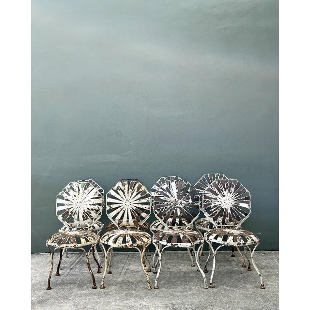 This substantial set of eight vintage Francois Carre garden chairs showcases the designer's signature sunburst motif...