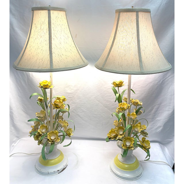 Gorgeous Italian tole table lamps from the mid 20th century. The hand painted metal tole lamps have painted yellow flowers...