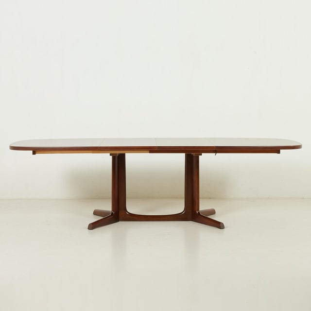 Refined Danish mid-century rosewood extendable table designed by Niels Otto Møller and manufactured by Gudme Møbelfabrik...