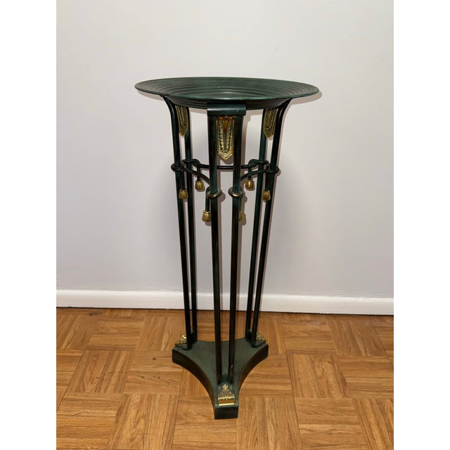 Elegant and architectural, this neoclassical-inspired pedestal features a slender blackened metal frame accented with...
