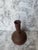 A unique vintage vase made of hand thrown unglazed earthenware. Likely produced in the 1970s. Copper brown or bronze tone...