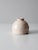 This is a vintage studio pottery vase. Signed by the artist, the hand-crafted vase has an inkwell shape with a cream glaze.