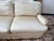 Twin custom silk upholstered sofas bring soft understated glamour with their creamy diamond-quilted seats and gently...