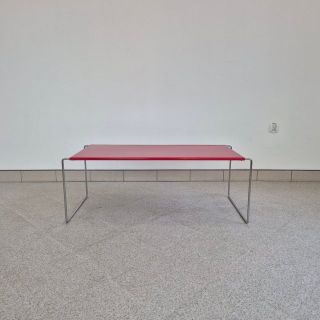 Simple lines, bold red and polished chrome give this side table a modernist look that remains fresh and appealing decades...