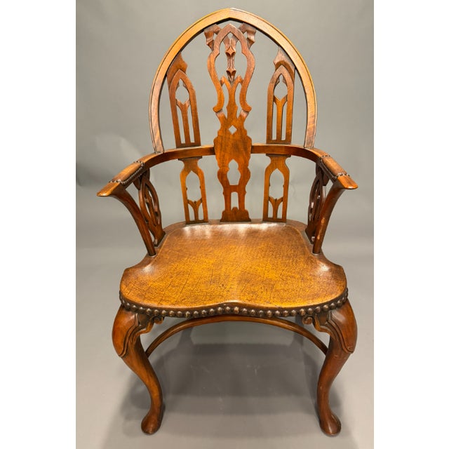 Set of 6 Gothic Windsor style dining chairs in mahogany, including four side chairs and two armchairs. The chairs feature...