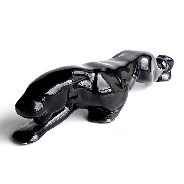 Offered is a vintage Royal Haeger brand glazed ceramic black crouching panther figurine with emerald green rhinestone...