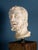 An elegant marble male head, with a finely sculpted beard and wavy hair, depicts a figure with his face turned heavenward,...