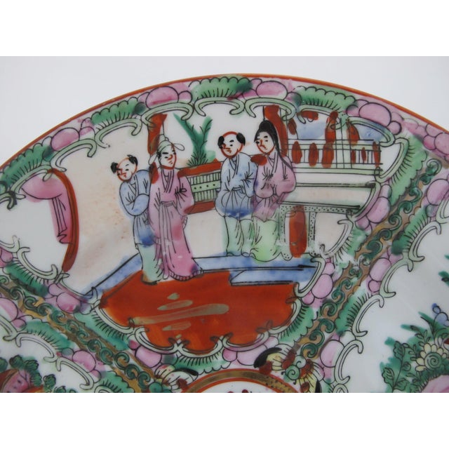 Chinese Rose Medallion porcelain plate featuring hand-painted panels of figures, birds, and flowers. Brightly colored in...