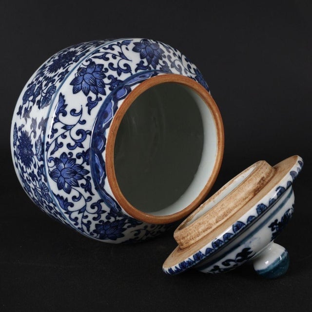 Elevate your home decor with this classic blue and white porcelain ginger jar. This elegant piece features a beautiful,...