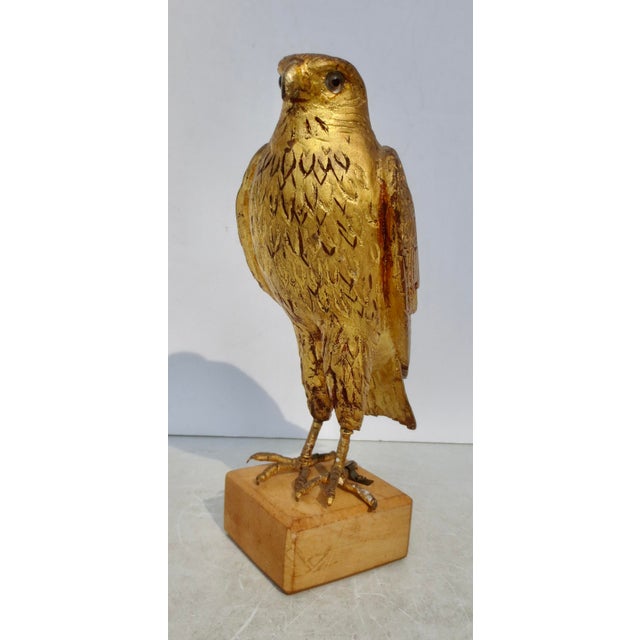 Vintage 50s' carved and gilt wooden Hawk. Carved in wood with glass eyes and standing on wrapped wire feet. The noble...