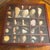 Beautiful collection of assorted natural seashells, thoughtfully arranged in individual divided compartments within a...