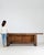 A substantial carpenter’s work table reflecting traditional workshop craftsmanship, featuring a long solid wood top built...