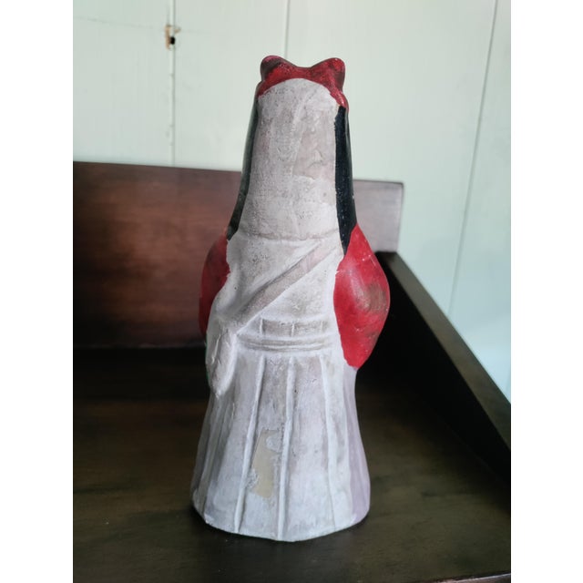 This Japanese figurine is made of porcelain and is vintage. I dont know who made it or when.