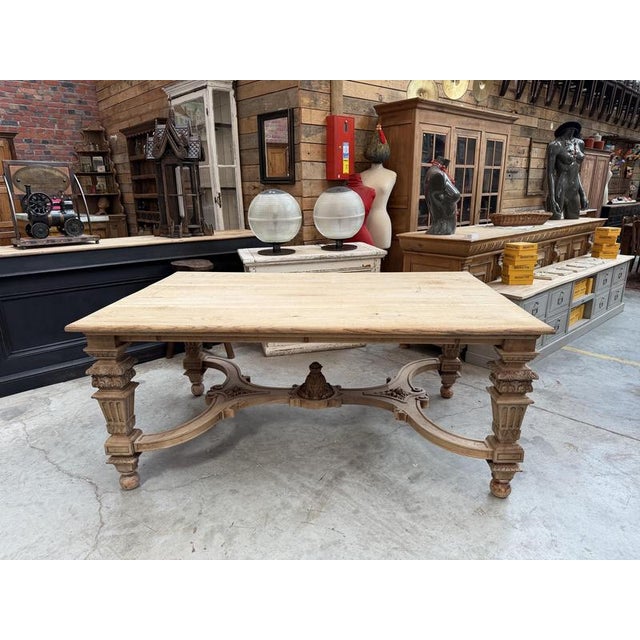 This magnificent antique table made of solid walnut has been fully restored. It features a large, stunning tabletop and a...