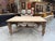 This magnificent antique table made of solid walnut has been fully restored. It features a large, stunning tabletop and a...