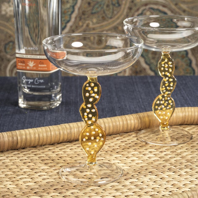 Elevate your cocktail experience with the Climbing Cacti Tequila Cocktail Glasses. Featuring a classic clear-finish coupe...