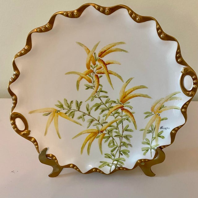 Remarkable antique condition, with minimal wear and heavy gold scalloped edges. This beautifully decorated plate dates...