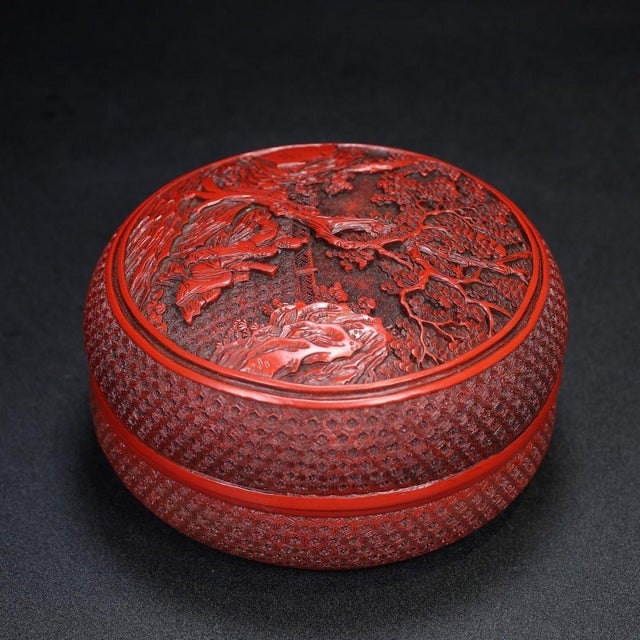 This is a substantial and exquisitely crafted carved lacquer box, featuring deep, intricate relief work in a rich,...