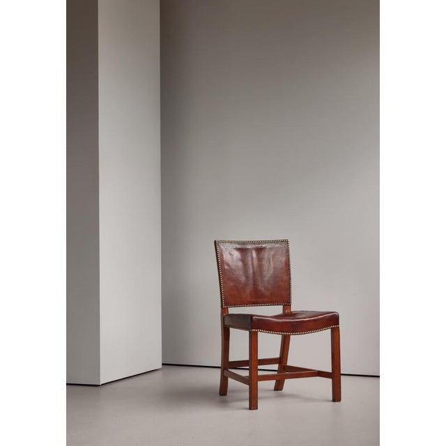 A rare 1937 example of kaare klint’s iconic red chair, executed in oak and retaining its original niger leather...
