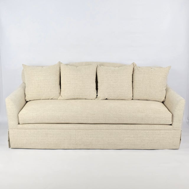 A beautifully tailored custom sofa created by M.J. Design Consultants in 2021. Neutral linen-toned upholstery, gently...