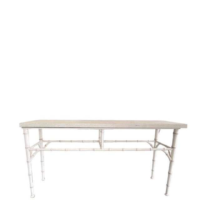 A refined outdoor console table by Michael Taylor, designed with a clean architectural profile and a bamboo-inspired metal...