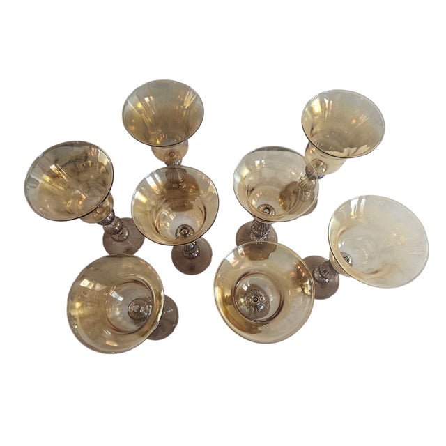Handblown vintage set of 8 art glass goblets, handcrafted in Murano, Italy. they feature a tulip shaped bowl and unique,...