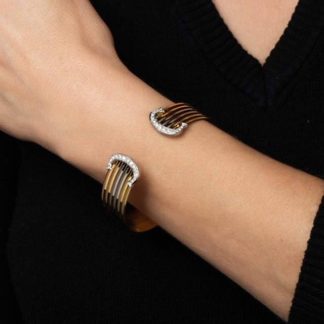 Vintage Cartier 'Double C' cuff bracelet crafted in 18 karat yellow, white & rose gold (circa 1980s). From the iconic C de...