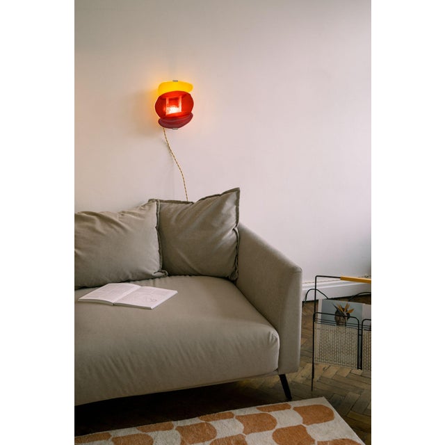 Handcrafted wall light born from the desire to blend light with the vibrant colors of abstract glass painting. Each piece...