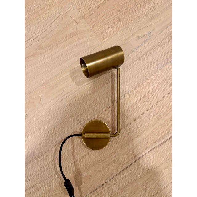 Elegant brass wall plug in light fixture with adjustable arm. Two scones, task lights, with swinging arm from Restoration...