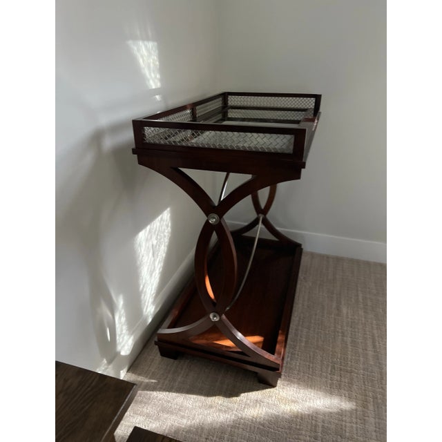 Gorgeous Mohagany server with antiques mirrored top, and bottom shelf. It also has hidden casters which makes moving it...