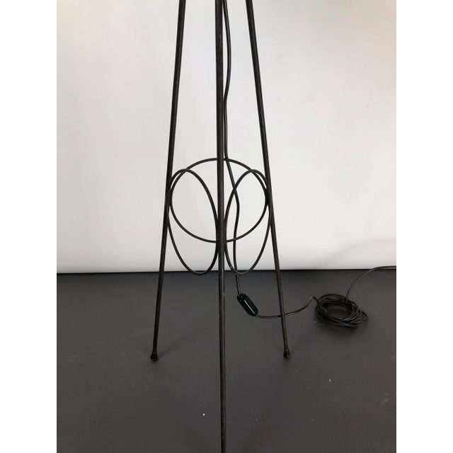 Great vintage condition with original patina for this Italian tripod floor lamp made from brass, lacquer and triplex...