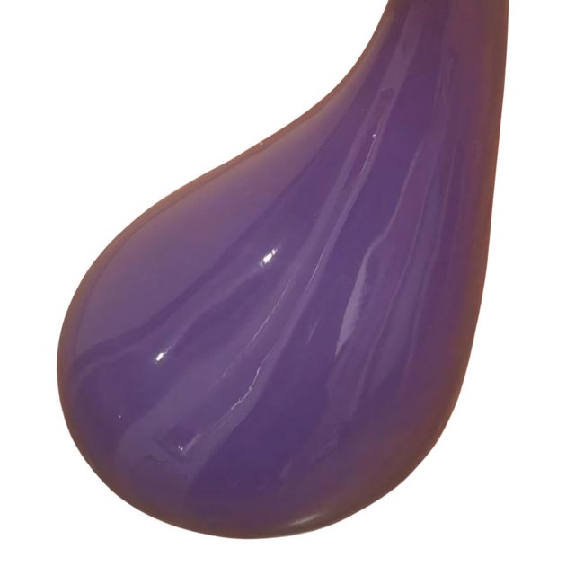 Striking postmodern side table featuring a sculptural, asymmetrical base executed in lacquered metal with a black finish....