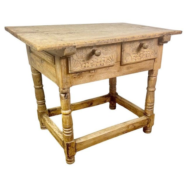 18th century bleached walnut Spanish Colonial table with two drawers. The four legs are connected by a stretcher. The two...