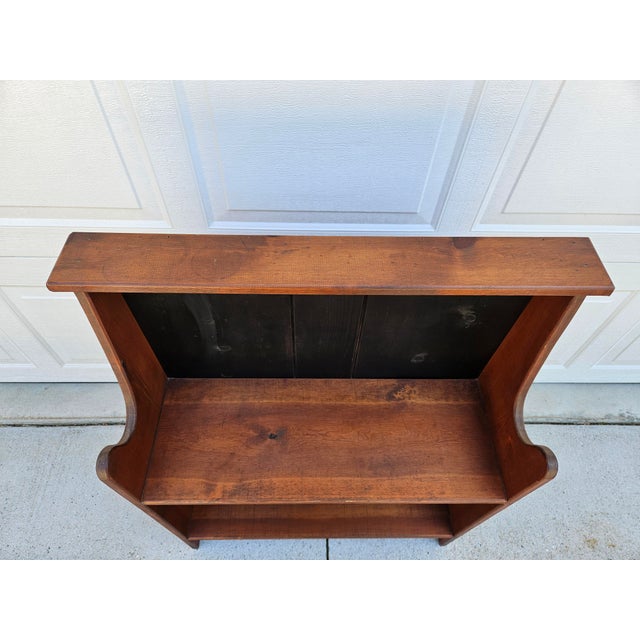 A primitive pine bookcase with two shelves and painted black panels to the rear. Each shelf has 10 inches of depth. This...