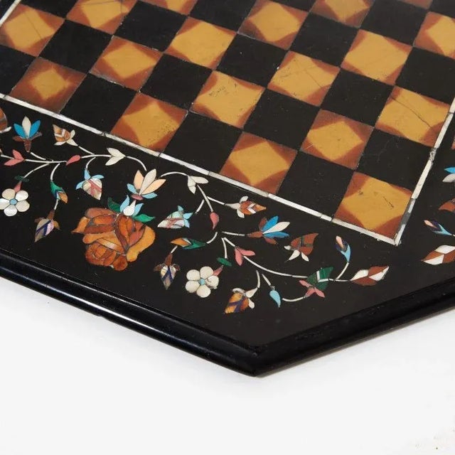 A mosaic chessboard made of natural stone, with floral decorations on the edges. (Without chess pieces) .43x43cm.