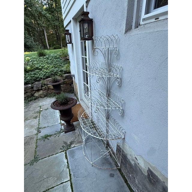 An antique four-tier painted wirework garden plant stand in the Victorian style. Based on its construction, materials,...
