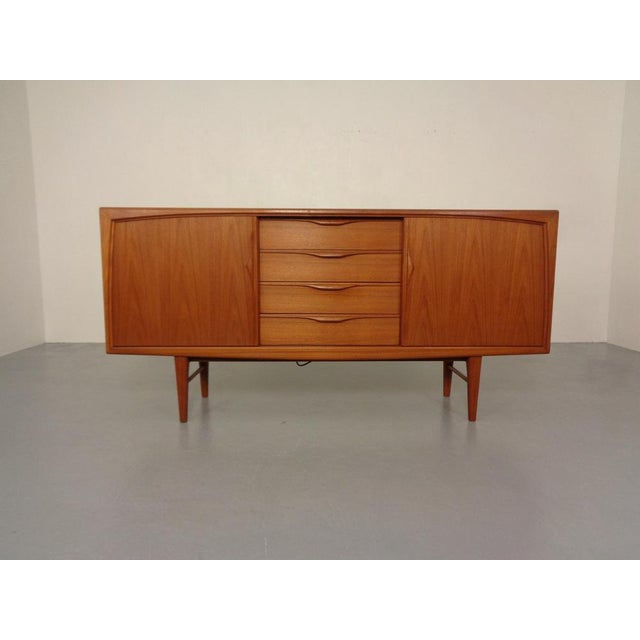 Teak sideboard from the 1960s. Design by Heinrich Riestenpatt. Two sliding doors behind each with a shelf. In the middle...