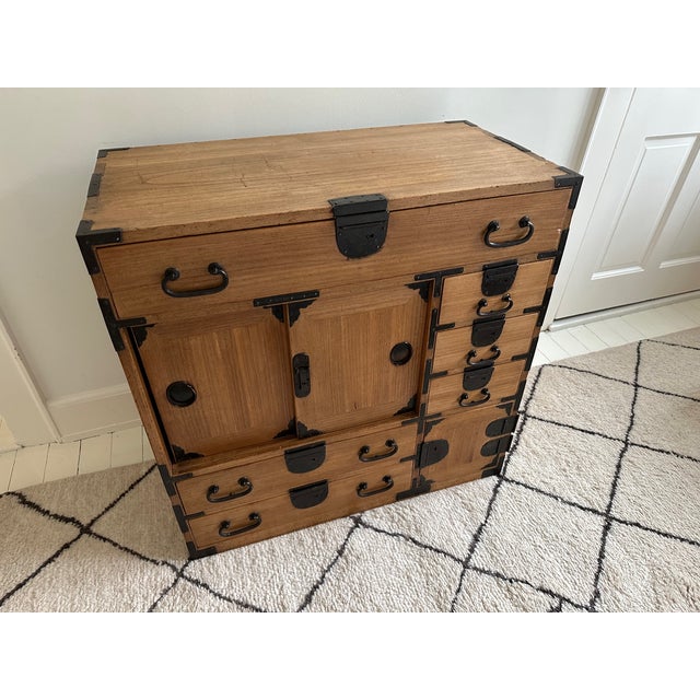 Beautiful antique Japanese tansu in 100% kiri wood with cast iron hardware. Featuring 6 drawers, a set of 2 sliding doors...