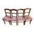Set of four antique Luterma chairs made in Estonia, with warm amber-brown wood, curved backs, and ornate fan-and-scroll...
