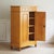 This light-colored, two-door vertical cabinet made of poplar wood dates from the second half of the 19th century, around...