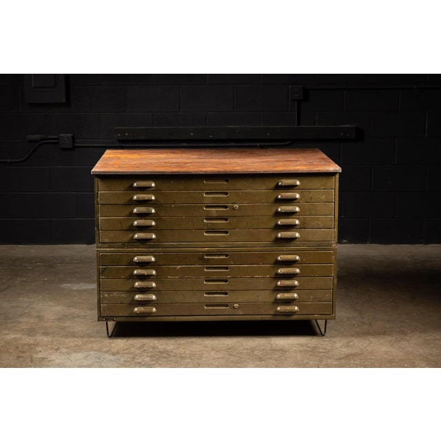 Vintage army green, steel flat file cabinet. This piece has had hairpin legs applied in-shop. Drawers (x10): 46" W x 35" D...