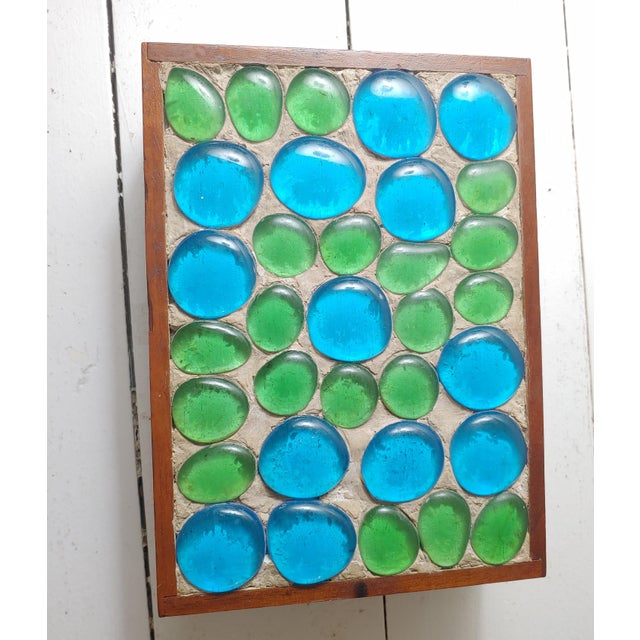 Here's a beautiful.hand made trinket or jewelry box. This is teak with a glass stone top. The inside is lined with velvet....