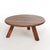 An Arts and Crafts Mission style low table offers oak construction with round top over splayed square legs, 20th century...