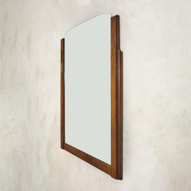 A French Art Deco wall mirror from the 1930s, framed in richly toned mahogany. Stepped side uprights and chamfered corners...