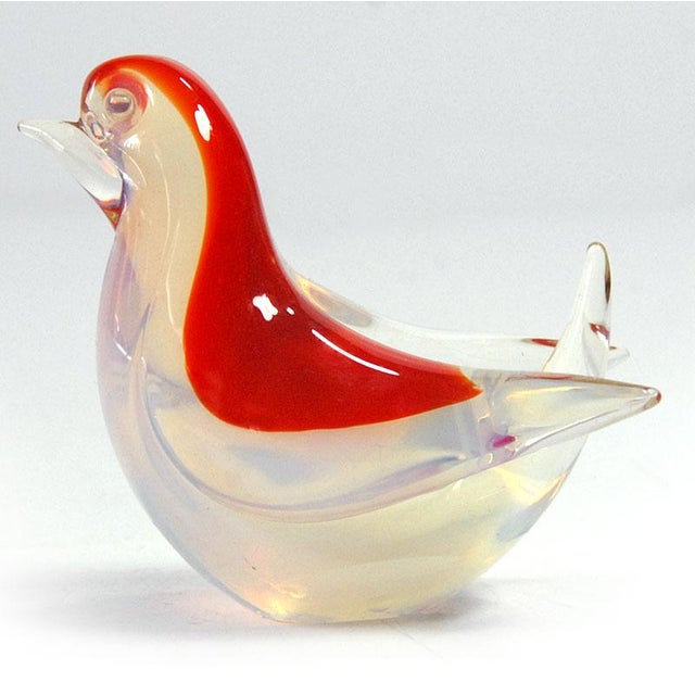A small, beautiful bird made of opalescent crystal glass. Additionally dyed locally in light red. The base is sanded. The...