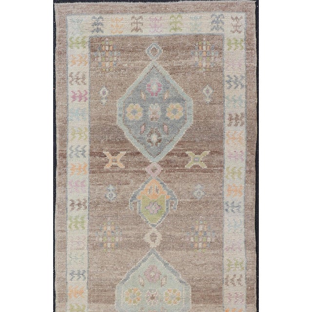 Tribal Turkish Oushak Runner With Soft Brown Field and Pale Blue Geometric Medallions For Sale - Image 3 of 12