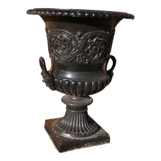 Extra Large Classical Mid 20th Century Cast Iron Garden Urn With Raised Scrolling Foliate and Figural Handles Face Design Stepped Base For Sale