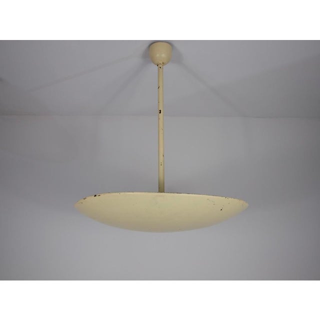 This 1960s metal ceiling lamp from Germany embodies the understated elegance of mid-century design. Featuring a clean,...