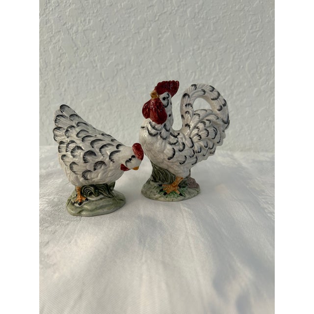 Charming pair of mid-century rooster and hen ceramic salt and pepper shakers with plastic stoppers. Dimensions: rooster,...