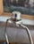 Tall mid-century modern table lamp featuring an open-form body constructed from curved wood ribs that swell outward before...